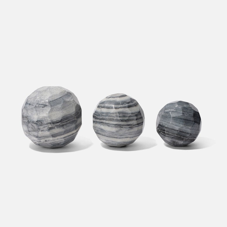 Three gray marble spheres on a white background
