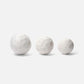 Three marble spheres of different sizes on a white background