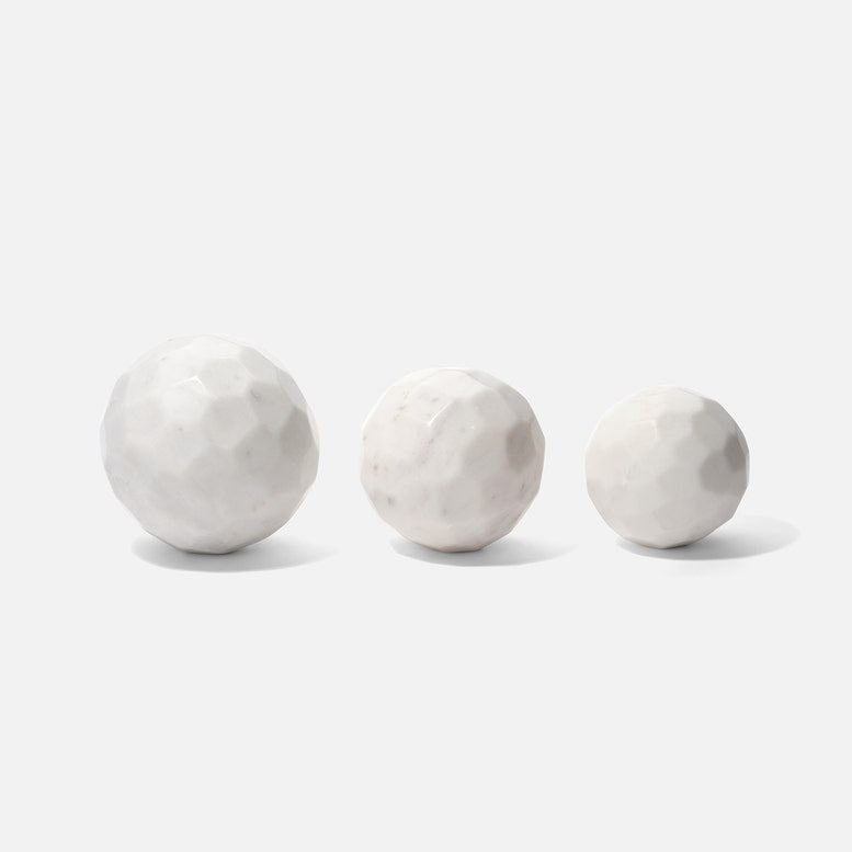 Three marble spheres of different sizes on a white background