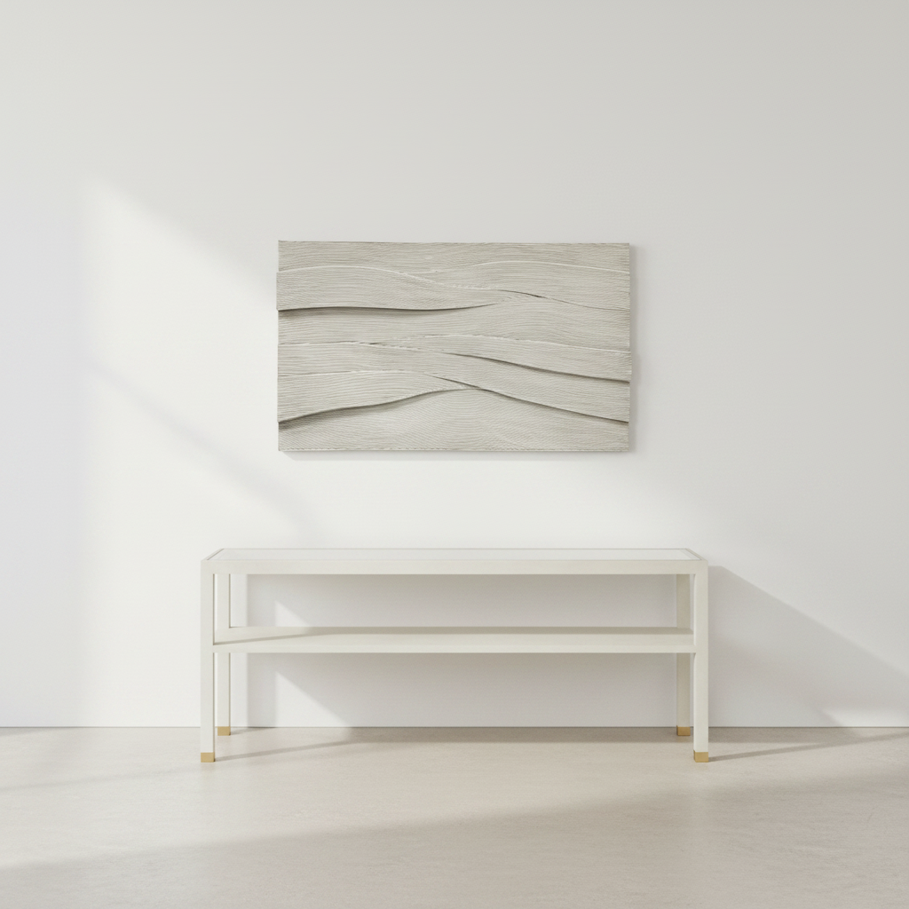 Abstract wall art piece on a white wall above a white console table.