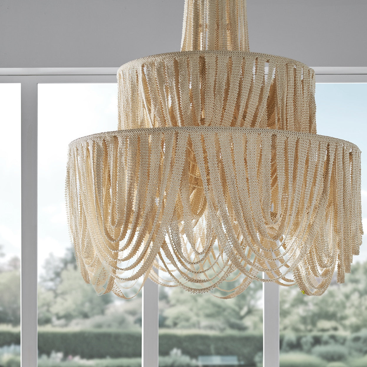 Beige beaded chandelier with a blurred outdoor background