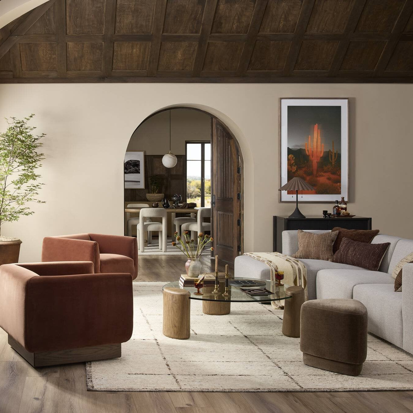 Living room with brown armchair, white sofa, and wooden cabinet.