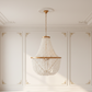 Beaded chandelier hanging in a room with white paneled walls