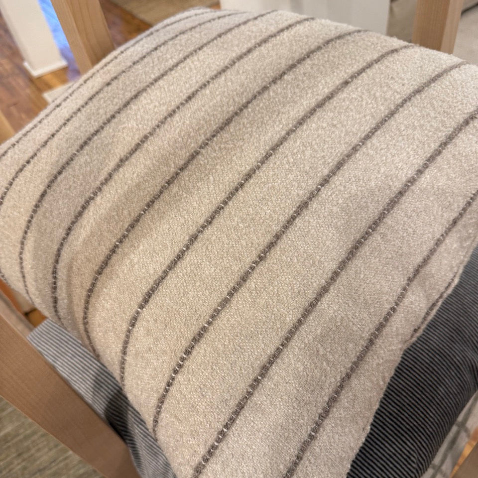 Textured cushion with striped pattern on a chair