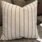 Striped pillow on a sofa with neutral tones