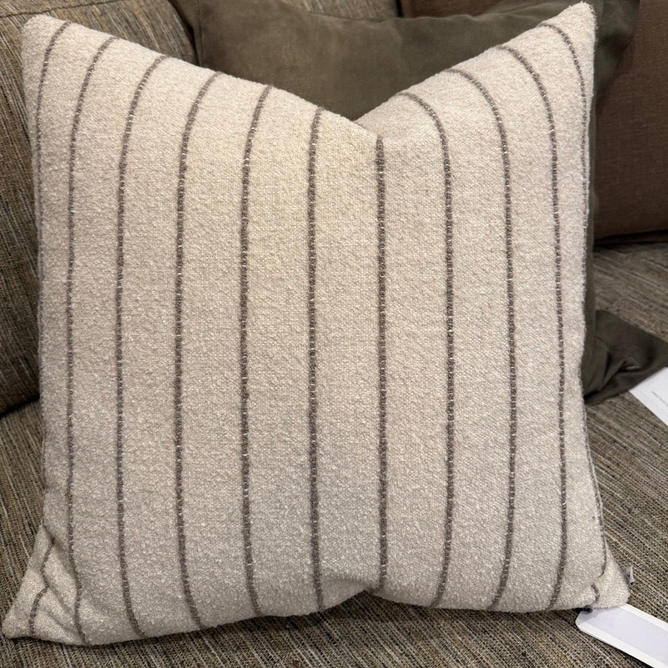 Striped pillow on a sofa with neutral tones