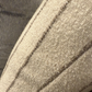 Close-up of a textured fabric surface with stitching details
