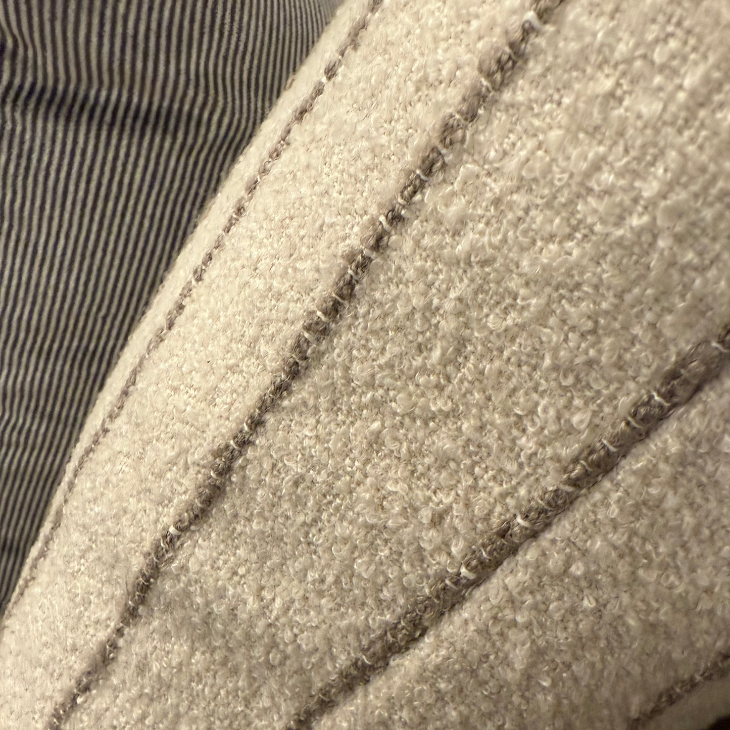Close-up of a textured fabric surface with stitching details