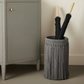 a styled photo of an umbrella stand in suede with fringe detail