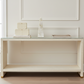 White console table with decorative items against a neutral wall.