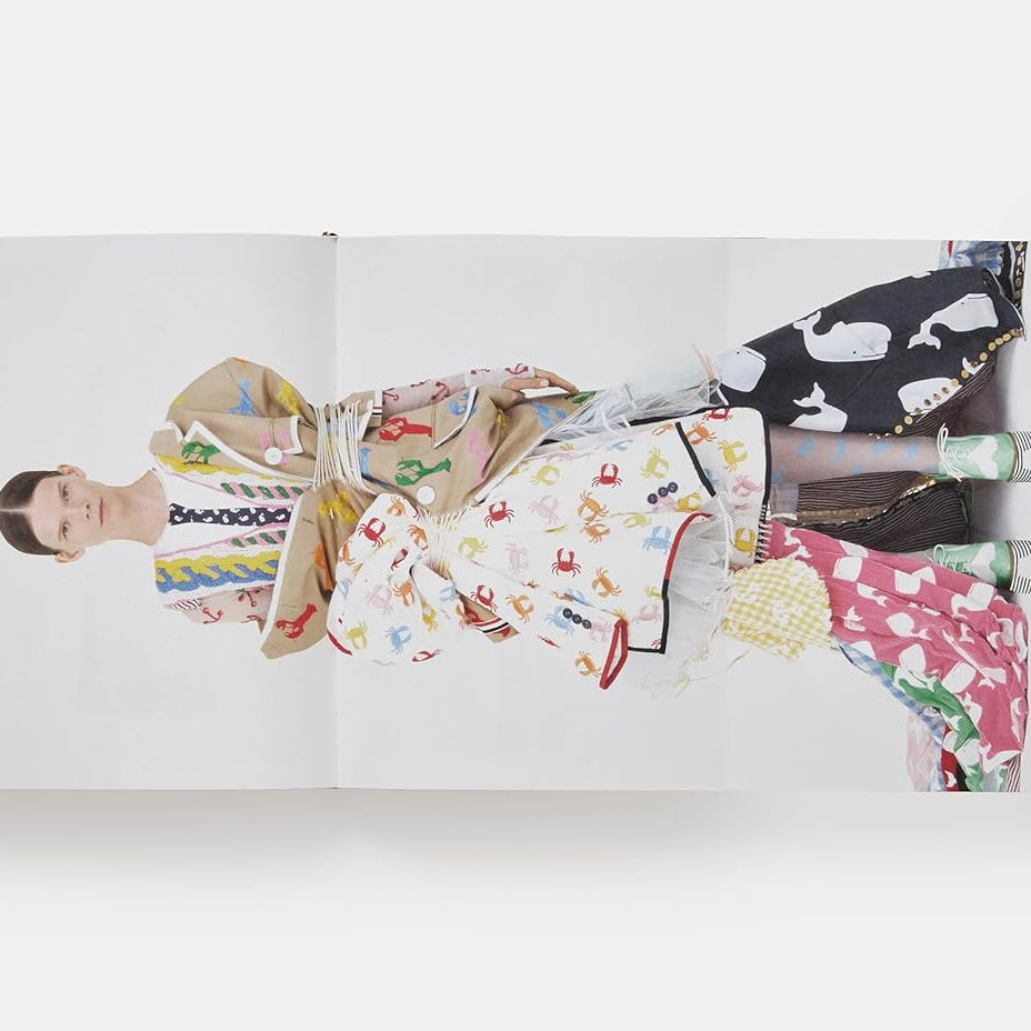 Open book displaying illustrations of people in colorful outfits on a white background