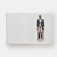 Mannequin wearing a formal suit with a white shirt and black bow tie on a white background
