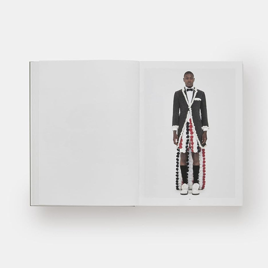 Mannequin wearing a formal suit with a white shirt and black bow tie on a white background