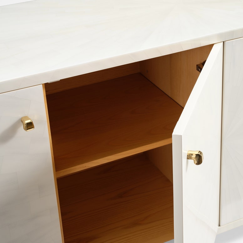 Wooden cabinet with white doors and gold handles