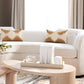 White sofa with patterned cushions in a living room setting