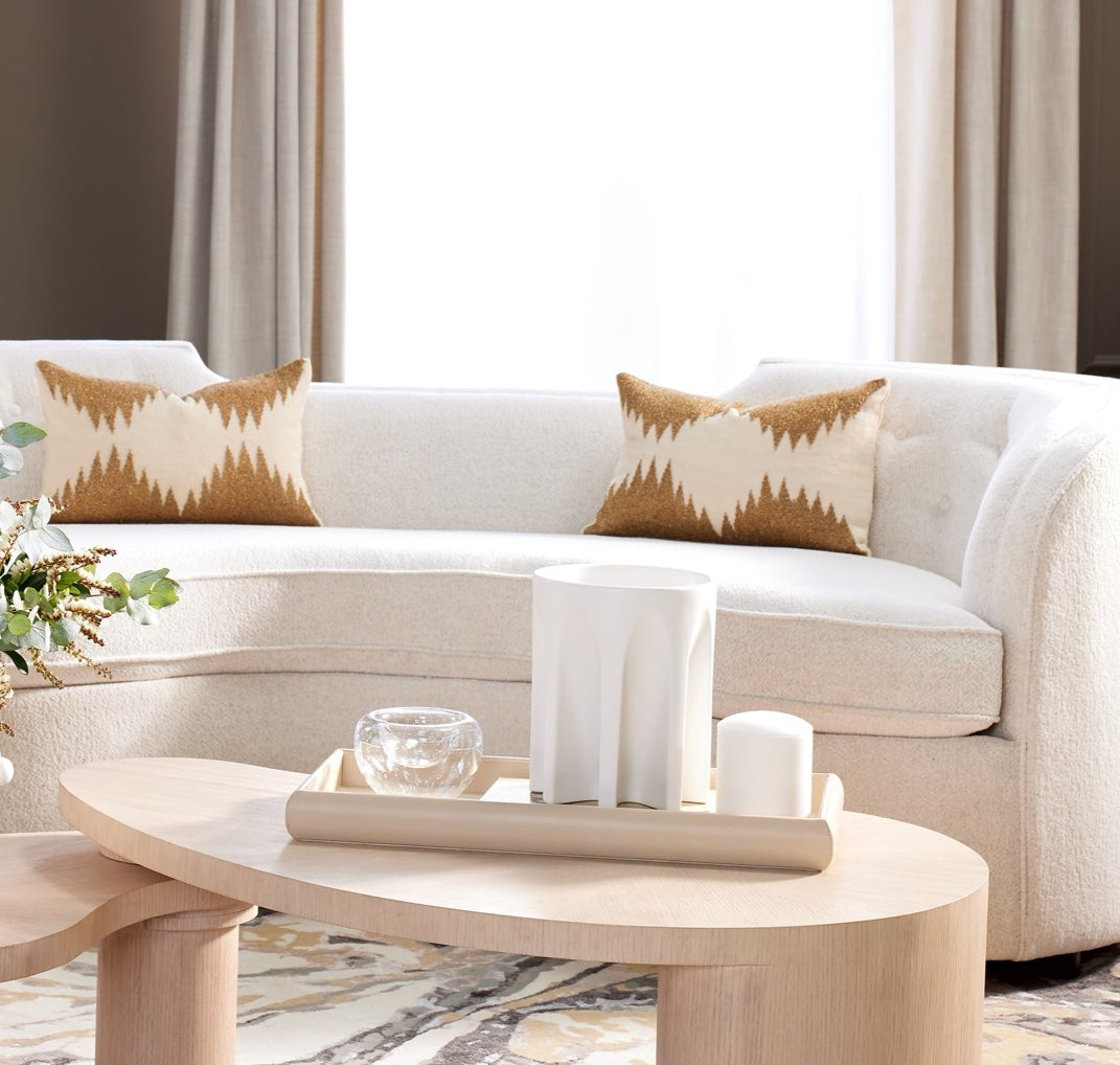 White sofa with patterned cushions in a living room setting