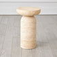 Beige stone side table on a wooden floor with a neutral background