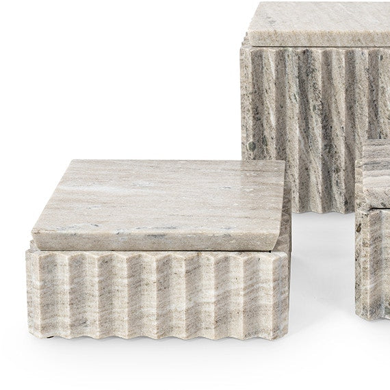 A set of modern stone boxes with fluted, ribbed bases and smooth rectangular tops in a light gray and beige marble-like finish, shown on a white background.