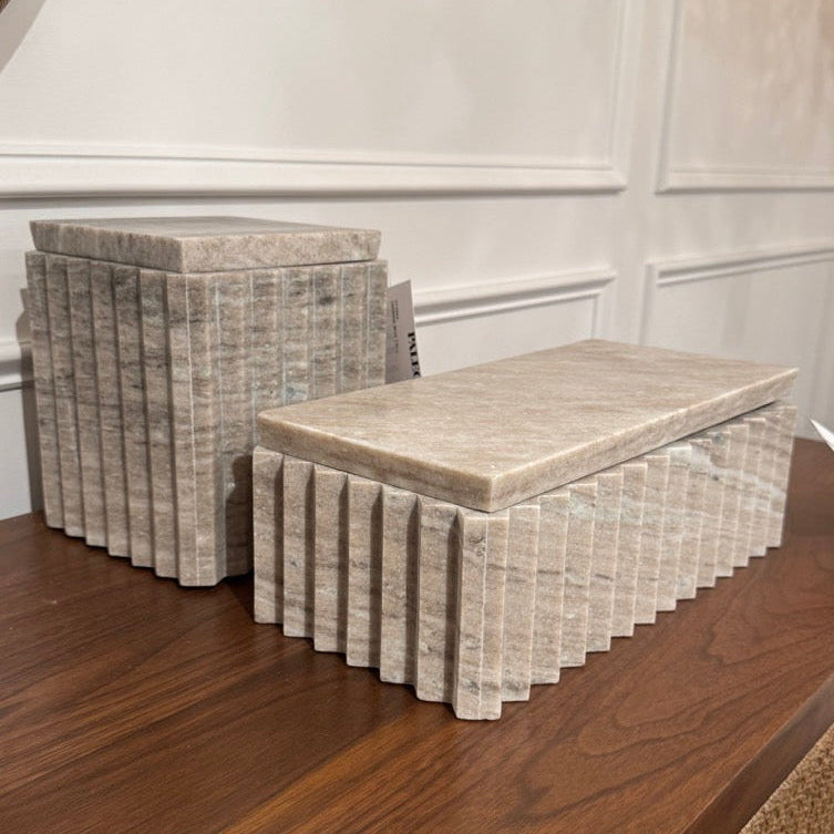 Decorative boxes with marble-like pattern on a wooden surface