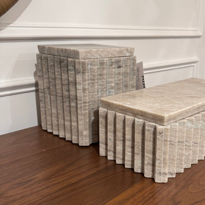 Decorative boxes with marble-like pattern on a wooden surface