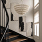 staircase showing a white wood cut disc chandelier