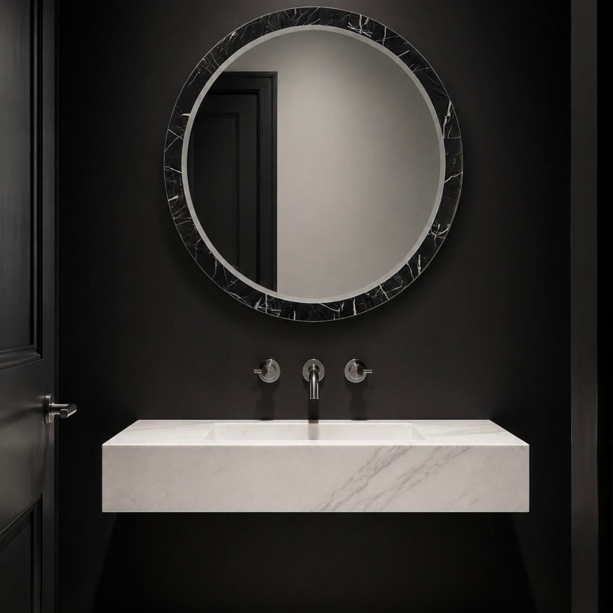 Black and white marble mirror hung in a black and white bathroom