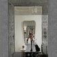 Decorative mirror with floral patterns on a textured wall