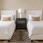 double black nightstand between two twin beds