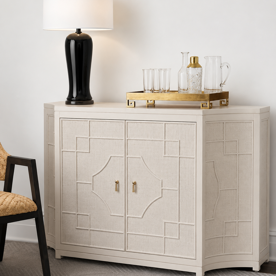 white sideboard with decorative items against a white wall