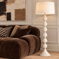 white textured floor lamp illuminated in a styled room