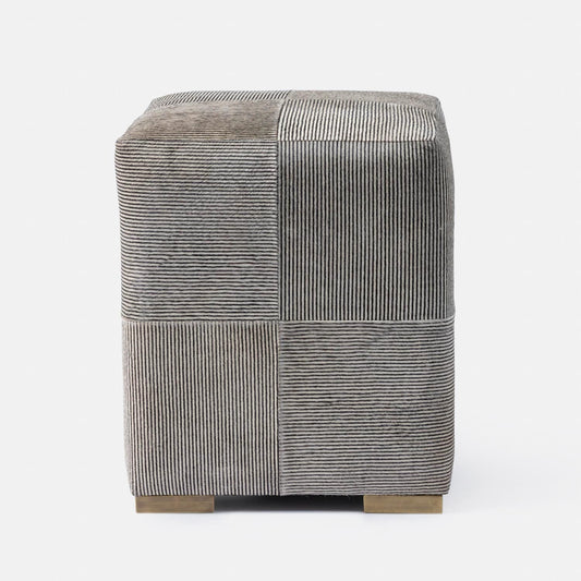 Textured cube stool with geometric pattern on a white background