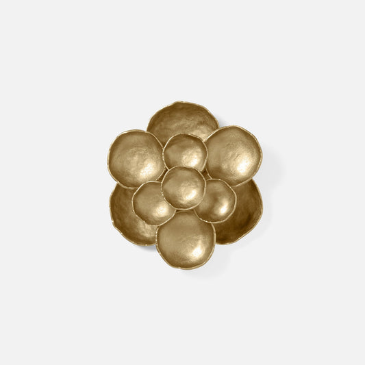 Gold floral-shaped decorative item on a white background