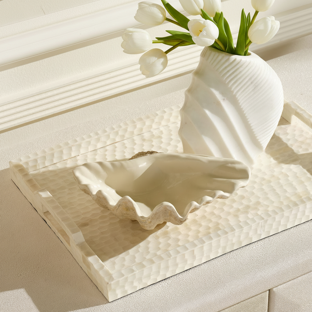 Decorative shell and vase with white tulips on a textured surface