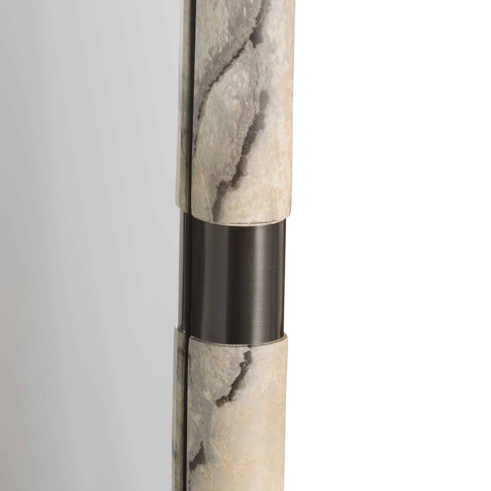 Marble-textured cylindrical object with a black accent on a light gray background