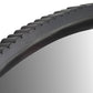 Close-up of a black tire tread pattern on a white background