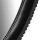Close-up of a black circular object with a reflective surface on a white background