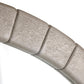 Close-up of a metallic cylindrical object with ribbed texture on a white background