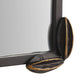 Close-up of a black metal frame corner with gold accents on a white background
