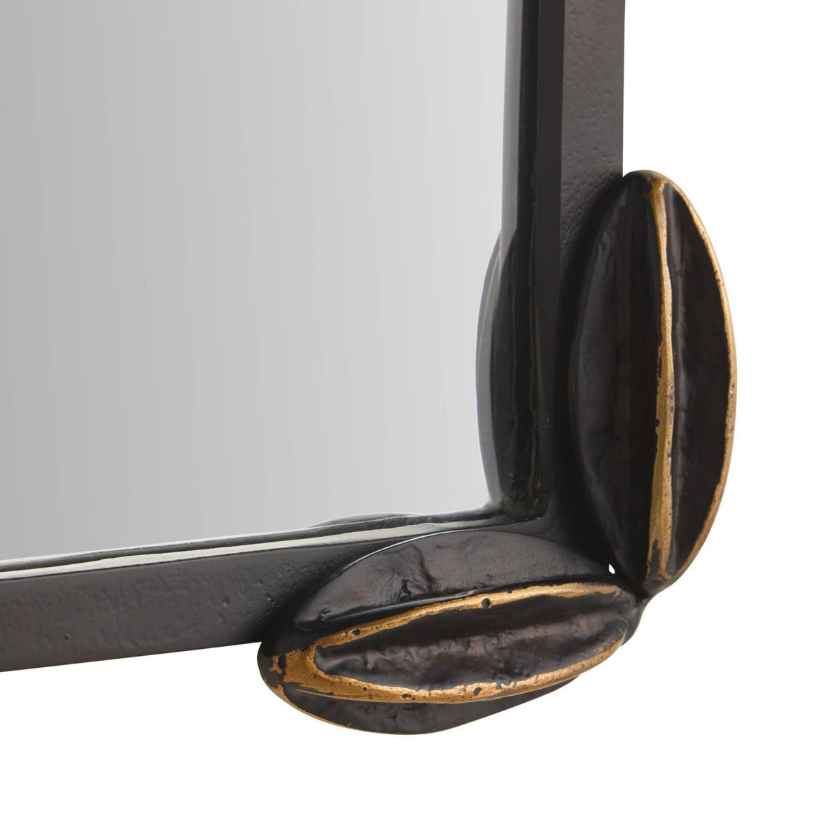 Close-up of a black metal frame corner with gold accents on a white background
