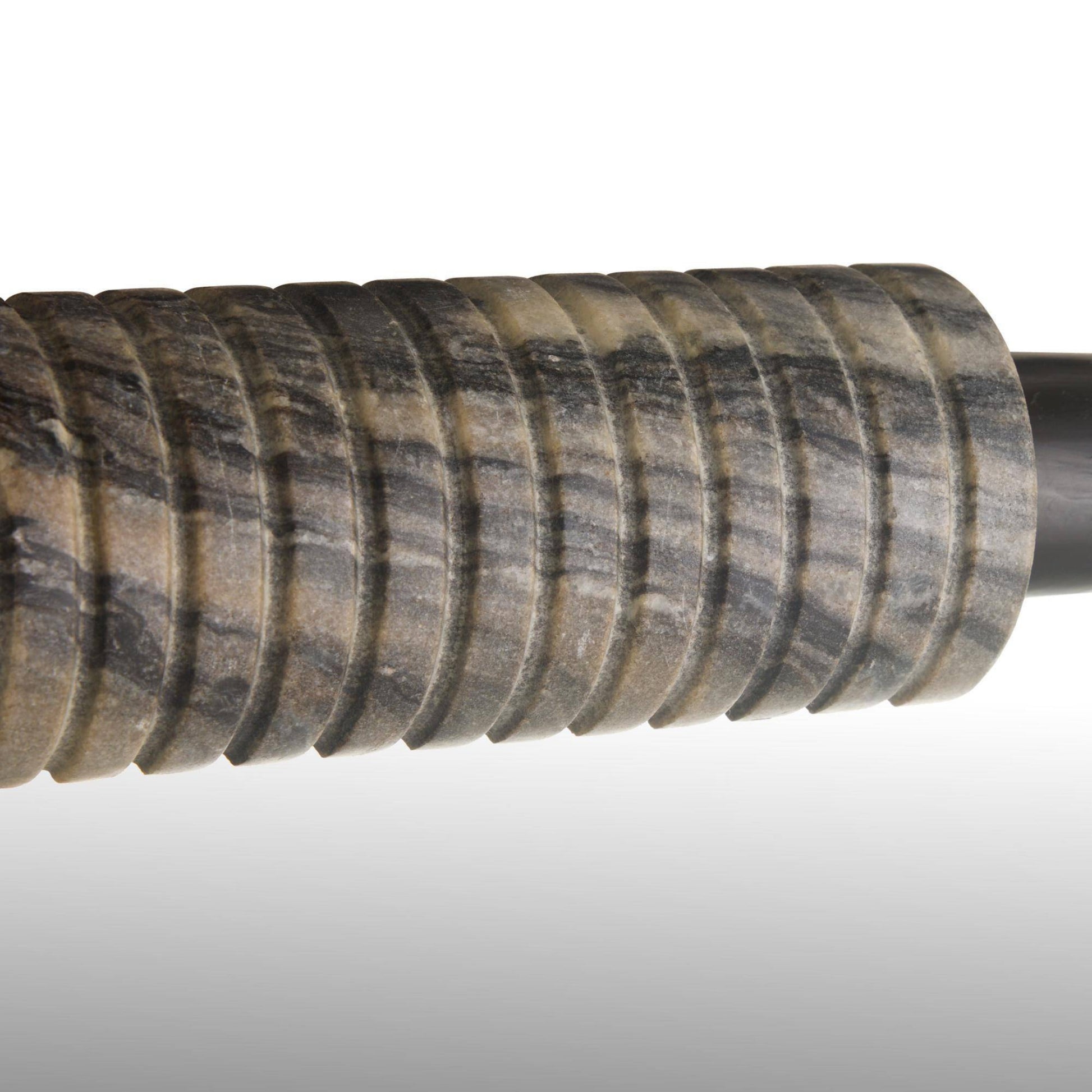 Close-up of a textured gun stock on a gray background