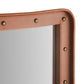 Close-up of a brown leather product with gold rivets on a white background