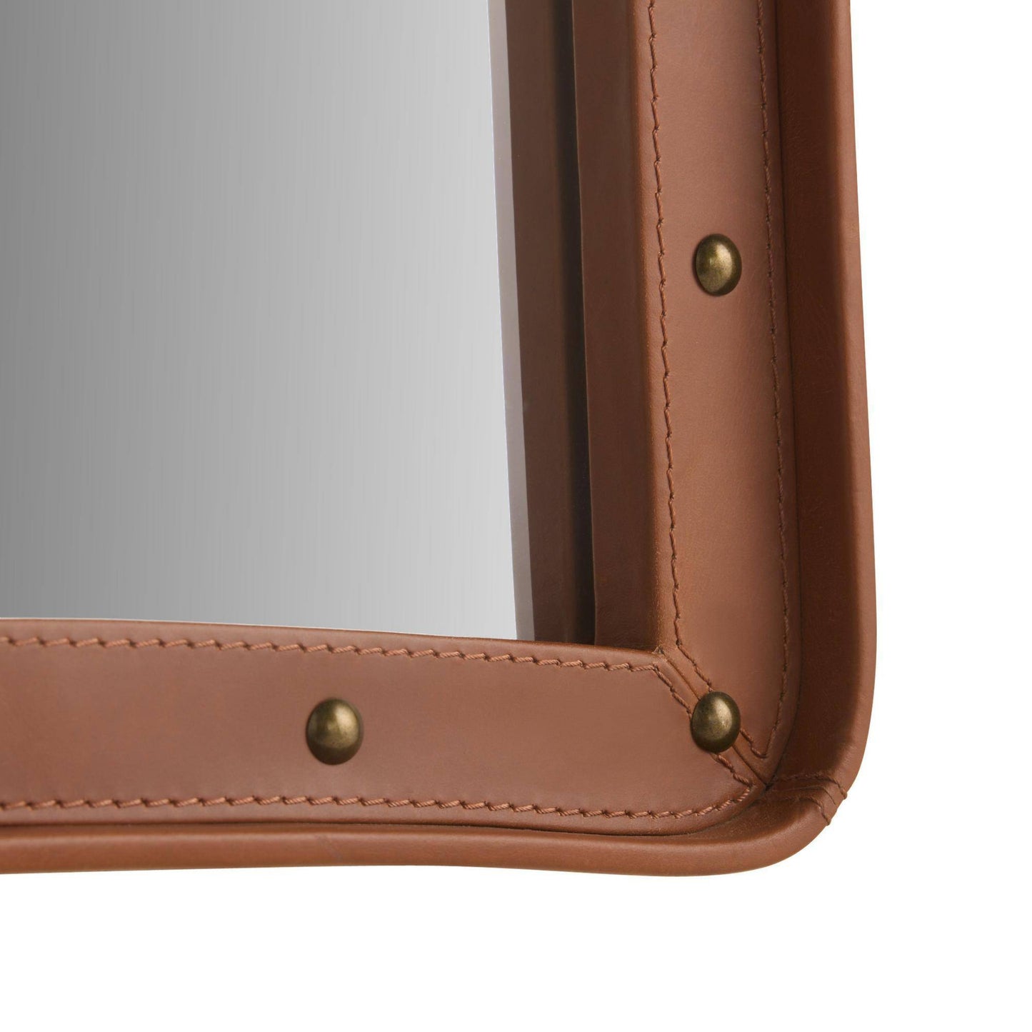 Close-up of a brown leather-bound book with gold rivets on a white background