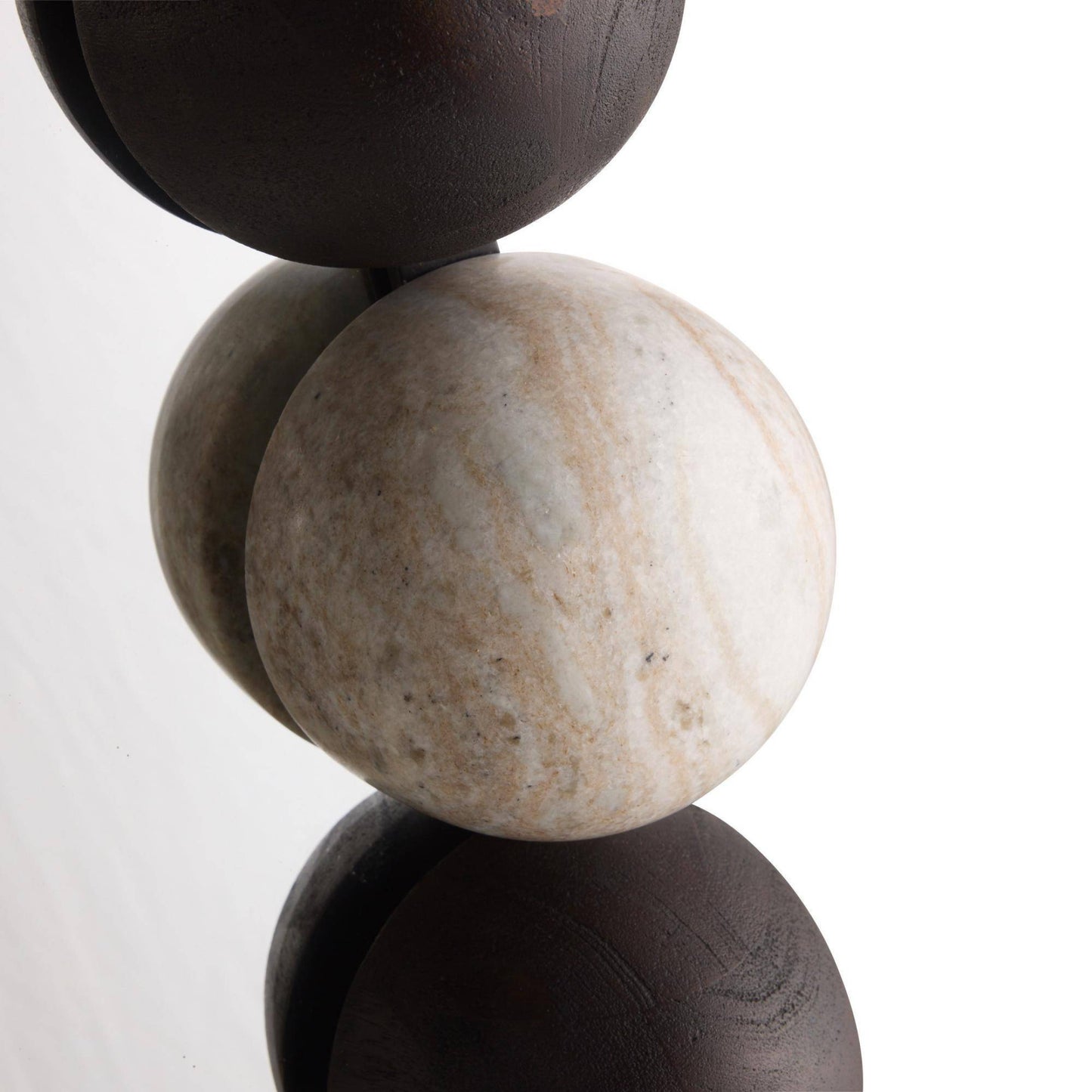 Three stacked stone spheres on a white background