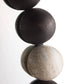 Close-up of stacked stone beads on a white background
