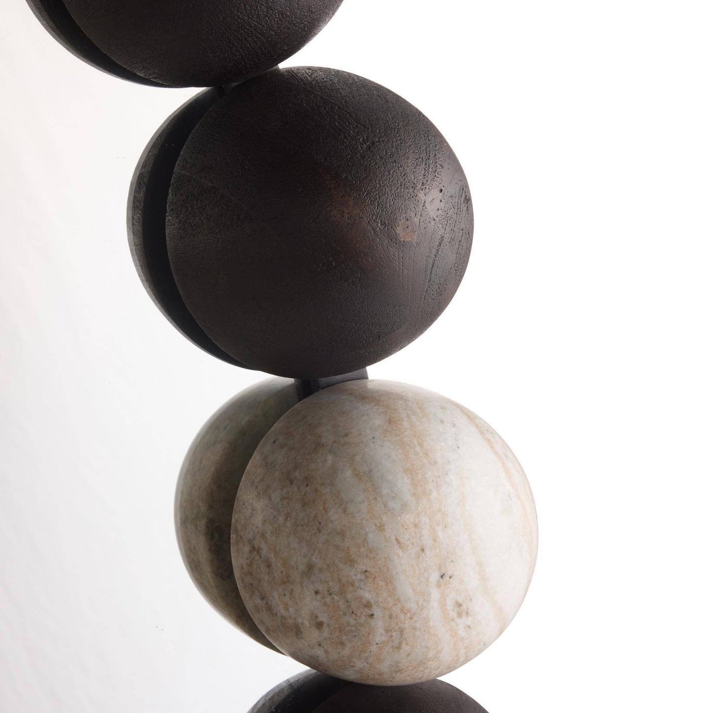 Close-up of stacked stone beads on a white background