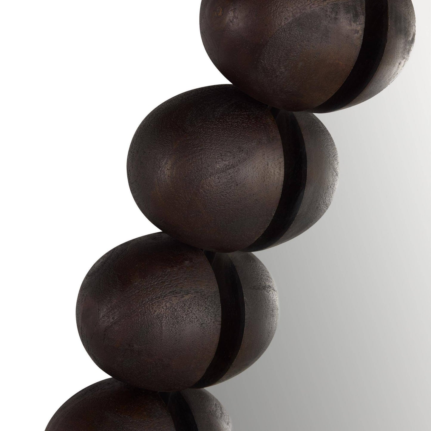Close-up of dark brown wooden beads on a white background