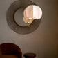 Modern pendant light fixture on a wall with a minimalistic design.