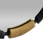 Close-up of a brown textured object with black attachments on a gray background