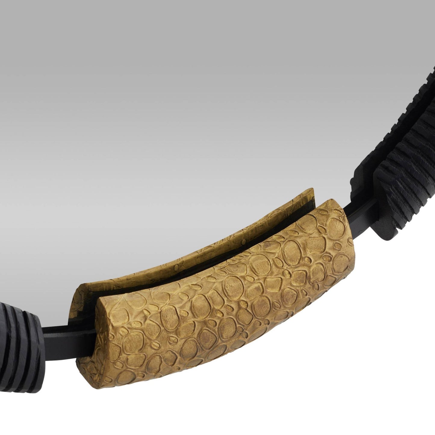 Close-up of a brown textured object with black attachments on a gray background