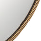 Round mirror with a gold metallic frame on a light gray background
